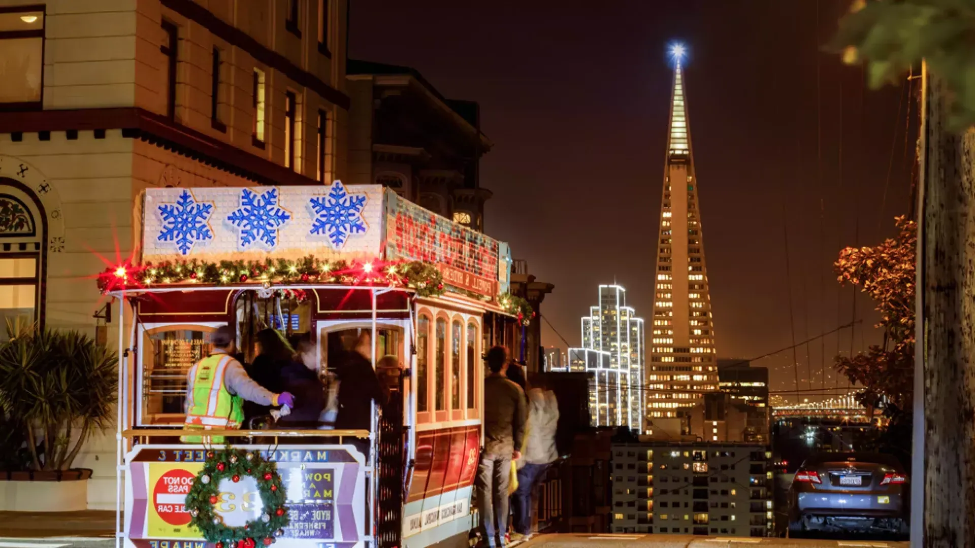 The cable cars are decorated for the holidays.